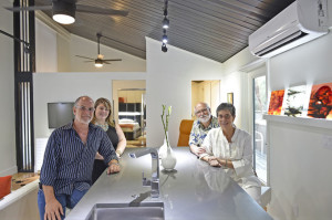In the completely renovated, reconfigured and updated 561-square-foot condo at Sandy Cove are (left) interior designers Mark Dalton and Jessica Napoli and on the other side of the table, homeowners Joy and Larry Scott, who bought the unit this past spring. They stayed at their primary home in Bath, Maine while the renovation took place over five months. They arrived in late September for the big reveal and to move in.  (September 16, 2015; STAFF PHOTO / THOMAS BENDER)