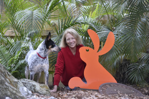 Homeowner Debbie Dart with Rocket, her four-year-old-rescue Australian cattle dog, and a curious rabbit that artist Debbie made for the back yard. From her home in Laurel Park, Dart can walk to her studio on Palm Avenue.  (January 06, 2015; STAFF PHOTO / THOMAS BENDER)