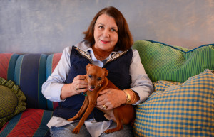Homeowner Judy Rossmoore Veale with her eight-year old miniature pincher, Curry. Veale got him at a Salvation Army charity auction. Curry weighs seven pounds.  STAFF PHOTO / RACHEL S. O'HARA