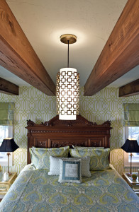The second floor master bedroom, done by designer Barbara Gardner of Collins Interiors and Linda Daniel, mixes vintage furniture with contemporary pieces for a fresh but elegant look. The homeowner loves seaglass blue and green combinations that speak to a Florida setting near the water. The bed is an Italian antique and the beams are an addition and not original to the 1926 home.  (February 09, 2016; STAFF PHOTO / THOMAS BENDER)