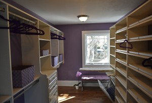 Purple closet/dressing room off the master bedroom that Bob Barthman of More Space Place designed and installed. Not huge by any means, the closet offers maximum efficiency (soft close drawers, pull-out ironing board) as well as beauty. Antique white cabinets are paired with satin nickel Hafele accessories and pulls. Barthman worked with homeowner Robin Thomas to customize the space to her lifestyle. Customization is a huge national design trend and it's available at all price points.  (February 26, 2016; STAFF  PHOTO / THOMAS BENDER)