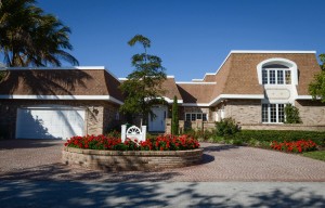 The front view of Chateau Aux Beau Visages, the 7,000-square-foot home on Tropical Circle, Siesta Key that is on the market for $2,950,000 through Peter G. Laughlin of Premier Sotheby’s International Realty. The owners are Dr. James and Beverly Marsh who have loved, improved and added to their French-inspired residence since 1980. They’ve decided to downsize and travel more often.  STAFF PHOTO/RACHEL S. O'HARA