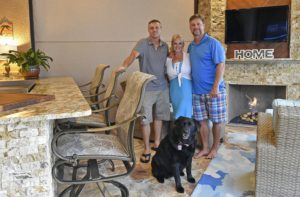 Builder Ross Davies with his clients Tracy and Russ Spengler and their black English Lab Vegas, whom they rescued nearly two years ago. Vegas loves the cool travertine marble floors in the lanai, but she won't have anything to do with the swimming pool. (July 8, 2016; STAFF PHOTO / THOMAS BENDER)