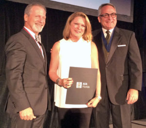 Sarasota's Cindy Peterson receives her Honorary AIA membership from Martin Diaz-Yabor, left, the 2016 AIA Florida president and AIA Florida past-president Andrew M. Hayes during the AIA Florida-Caribbean convention July 23 in Palm Beach. Staff photo / Harold Bubil
