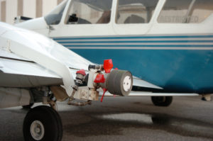 In Sarasota County's war on mosquitoes, the Micronair AU-4000 Rotary Atomizer, one on each wing of a Piper Aztec twin-engine airplane, is the key weapon. The size of the pesticide droplet dispersed from the atomizer size can be adjusted by varying the speed of the red rotors. The ideal droplet size to kill a flying adult mosquito is 26 microns. Vector Disease Control International flies the evening mosquito missions under contract to Sarasota County out of Dolphin Aviation at Sarasota-Bradenton International Airport. Staff photo / Harold Bubil; 8-30-2013.